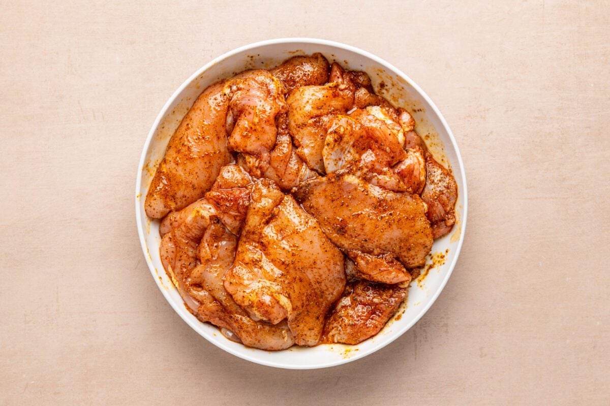 chicken tossed with oil, salt, chile powder, cumin, oregano, smoked paprika, and garlic powder in large bowl