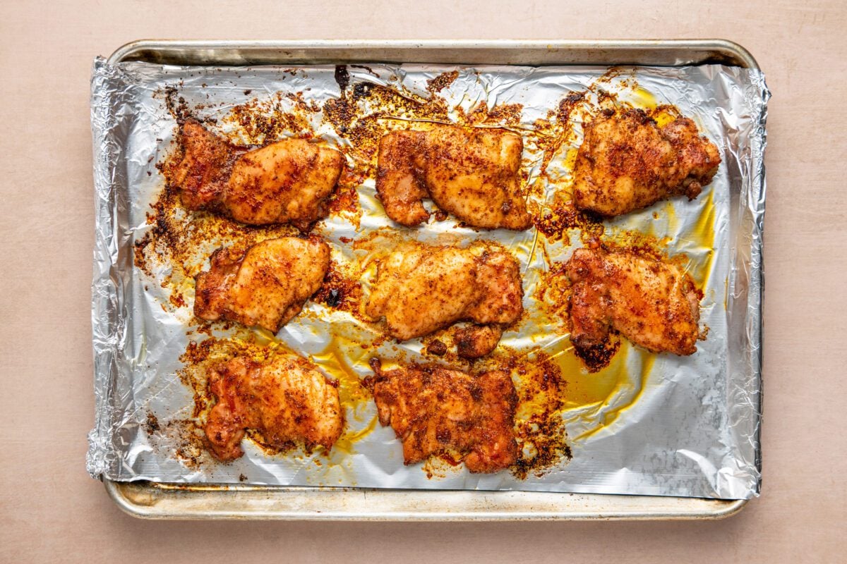 cooked chipotle chicken on foil-lined baking sheet