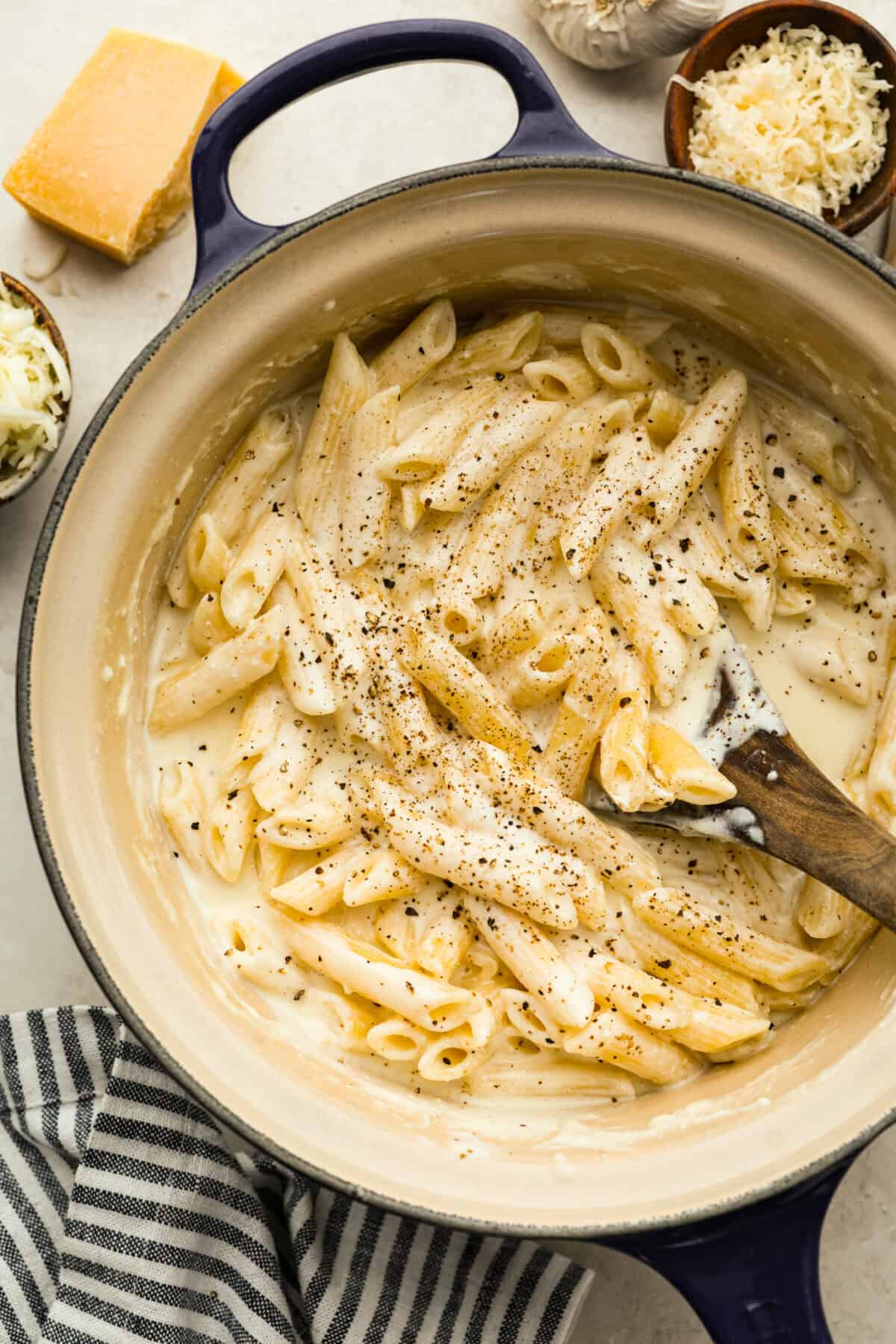 Four cheese pasta cooked and seasoned with pepper in a pan. 