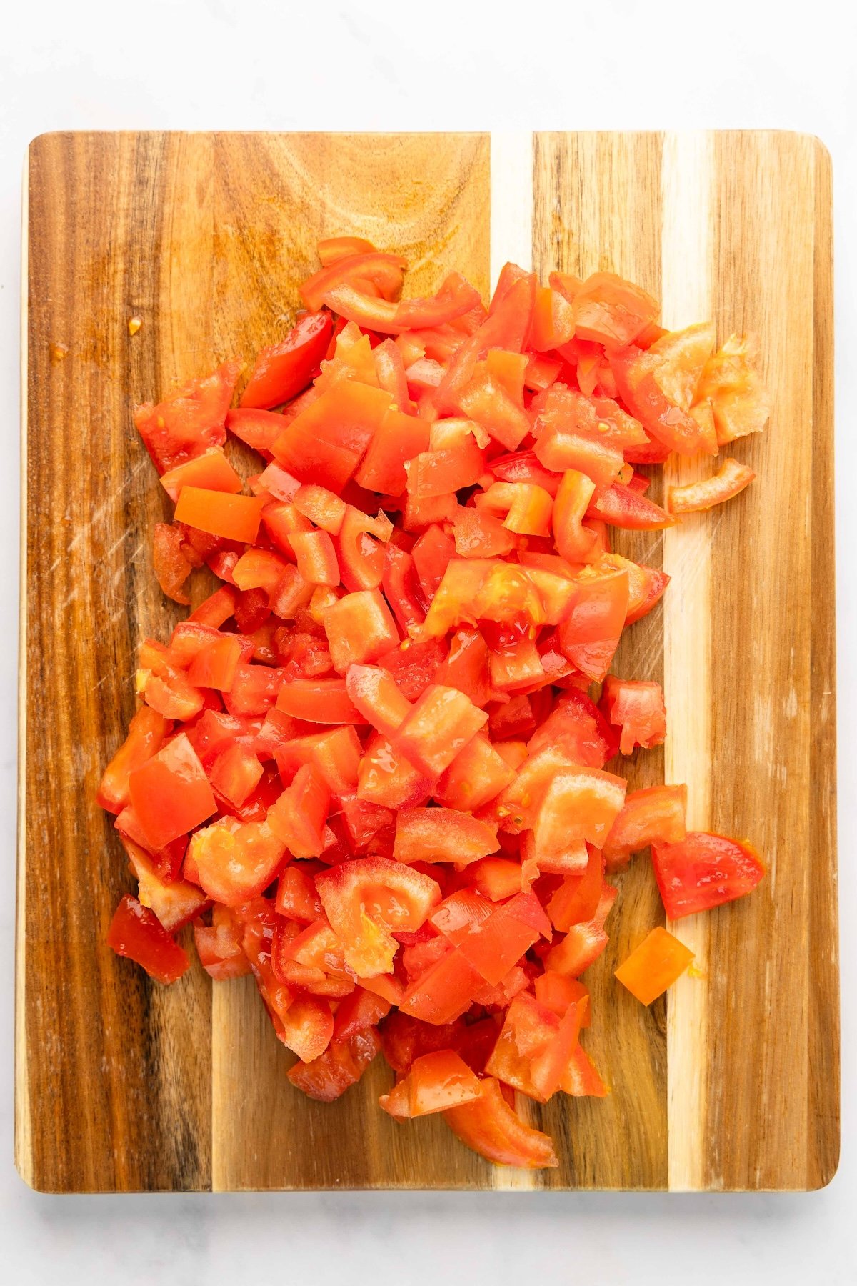 diced tomatoes on wood cutting board