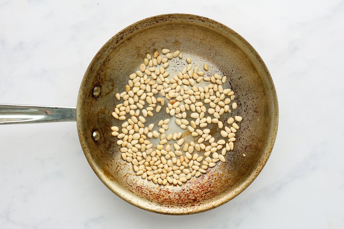 pine nuts toasting in small dry skillet