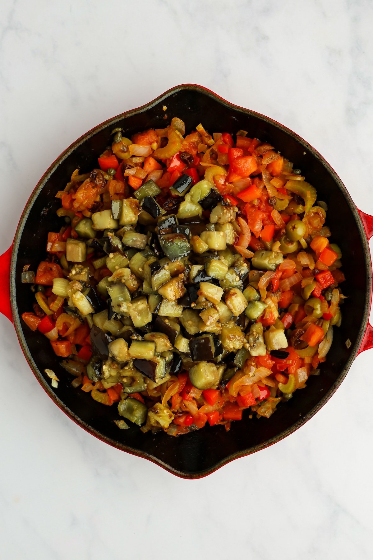 large skillet with cooked eggplant on top of cooked vegetable mixture