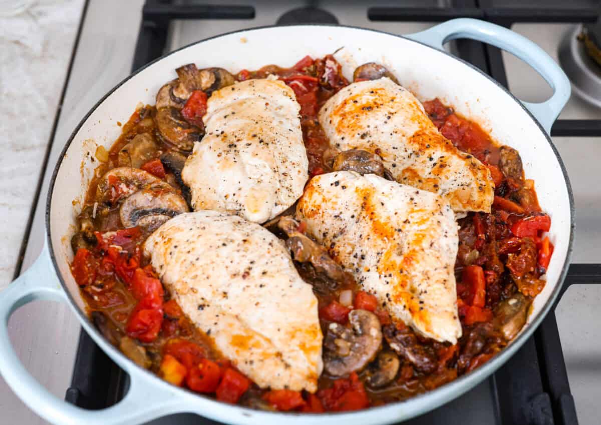 Chicken added back to the veggies in the skillet.