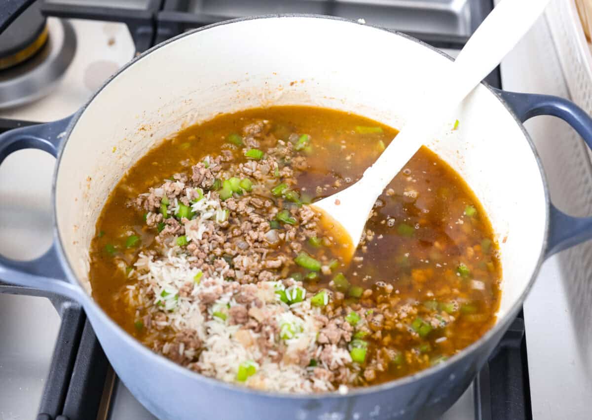 Broth and rice added to the meat and veggie mixture. 