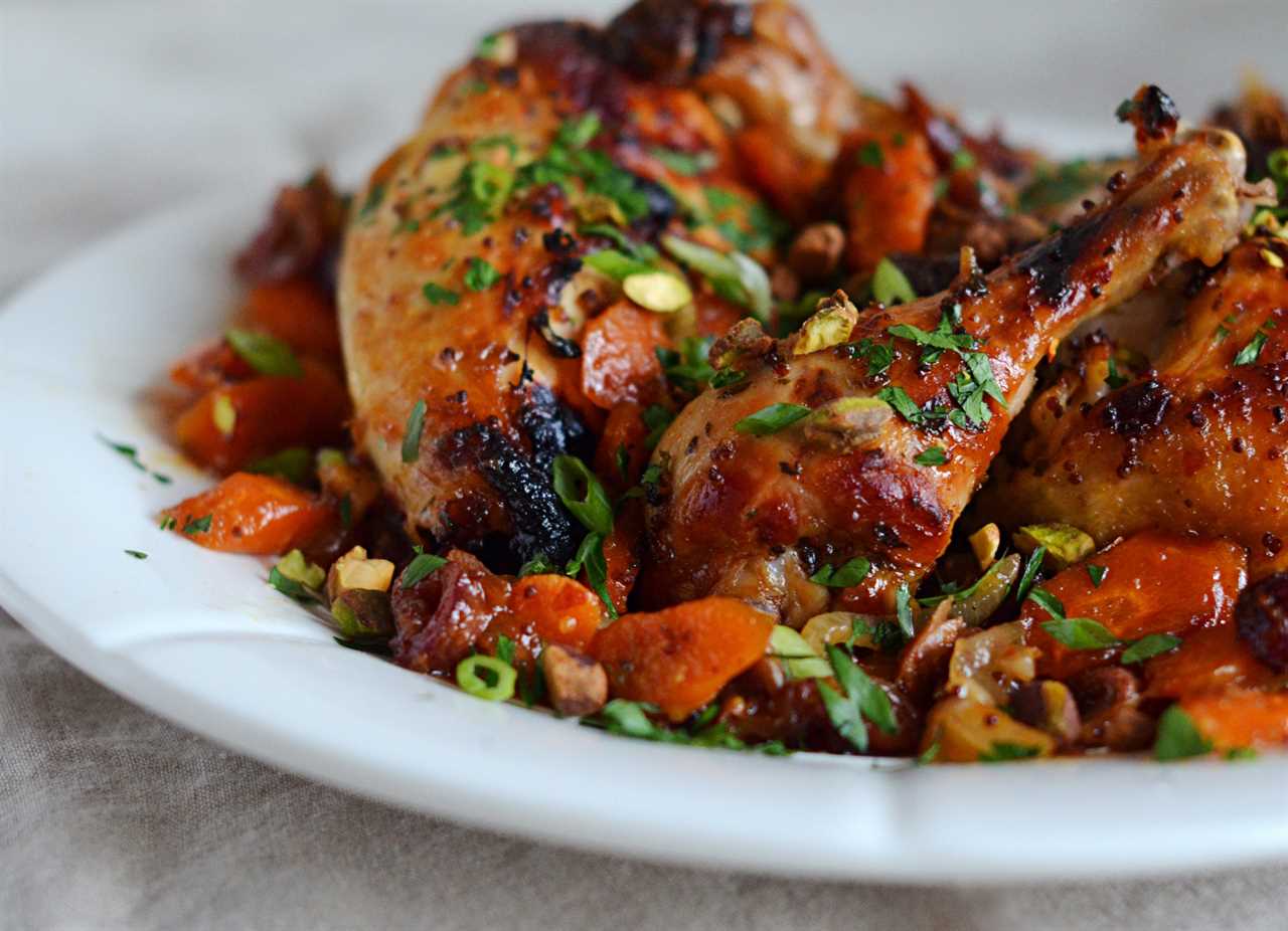 Plate of sweet and spicy roast chicken with carrots, dates, and pistachios.