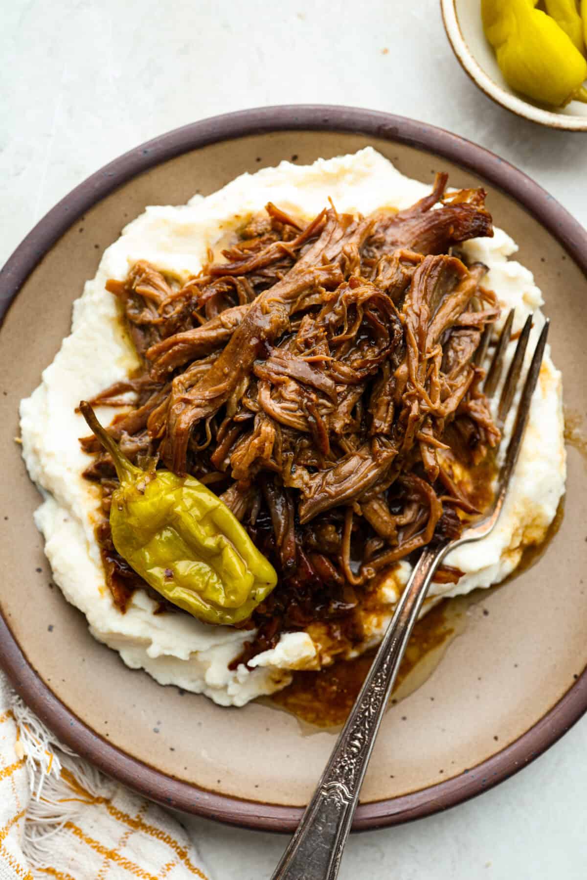 Plated Mississippi pot roast on mashed potatoes. 