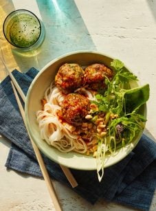 Vietnamese-style meatballs with chili sauce in a bowl over noodles.