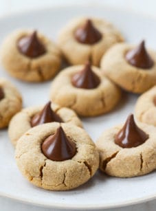 Peanut butter blossoms on parchment paper.