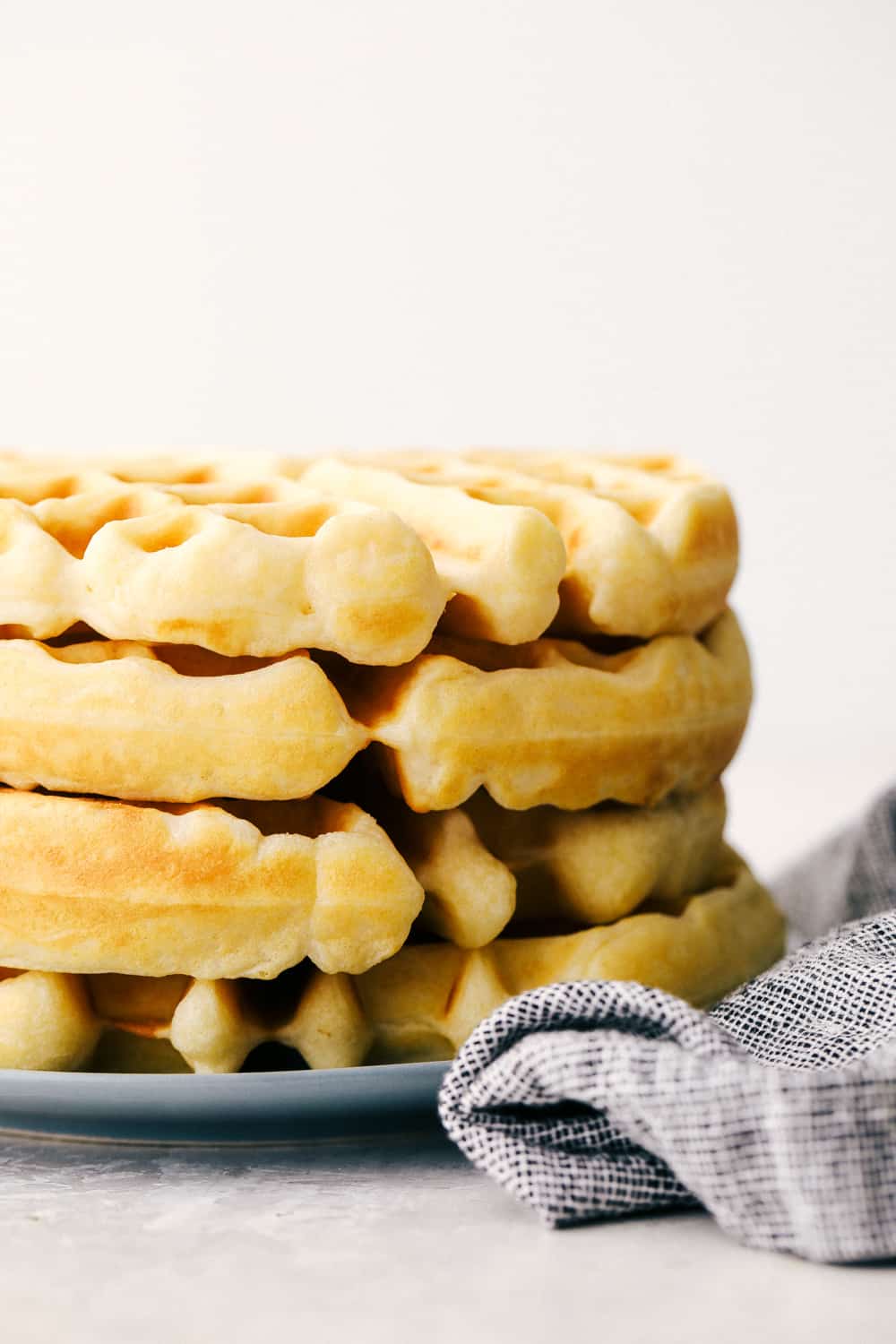 Stack of Belgian waffles on a plate. 