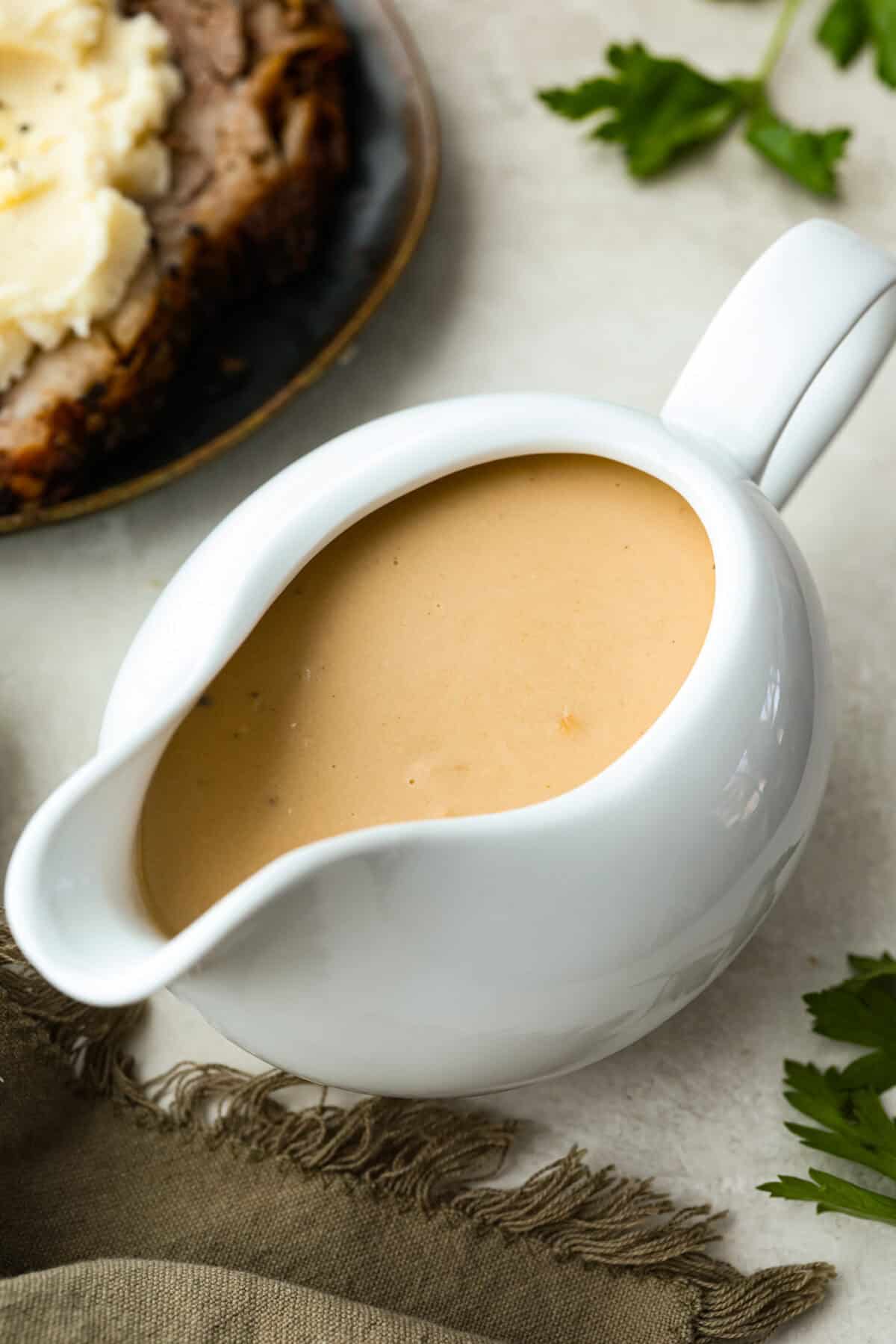 Gravy boat filled with sour cream gravy. 