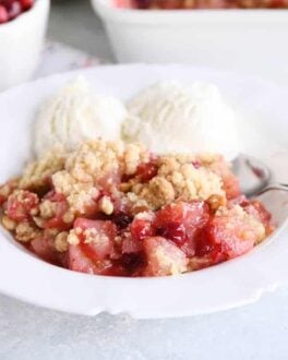 Bowl of cranberry pear crumble with vanilla ice cream.