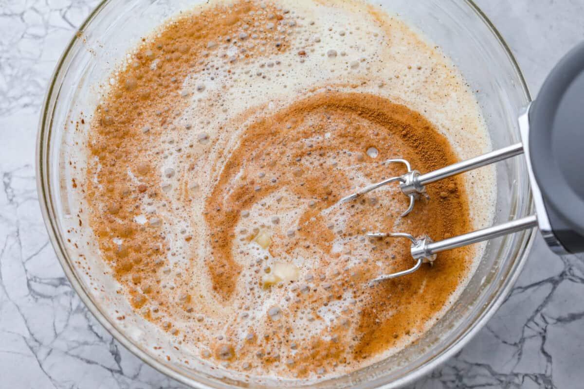 Adding the seasonings and mashed banana to the egg mixture. 