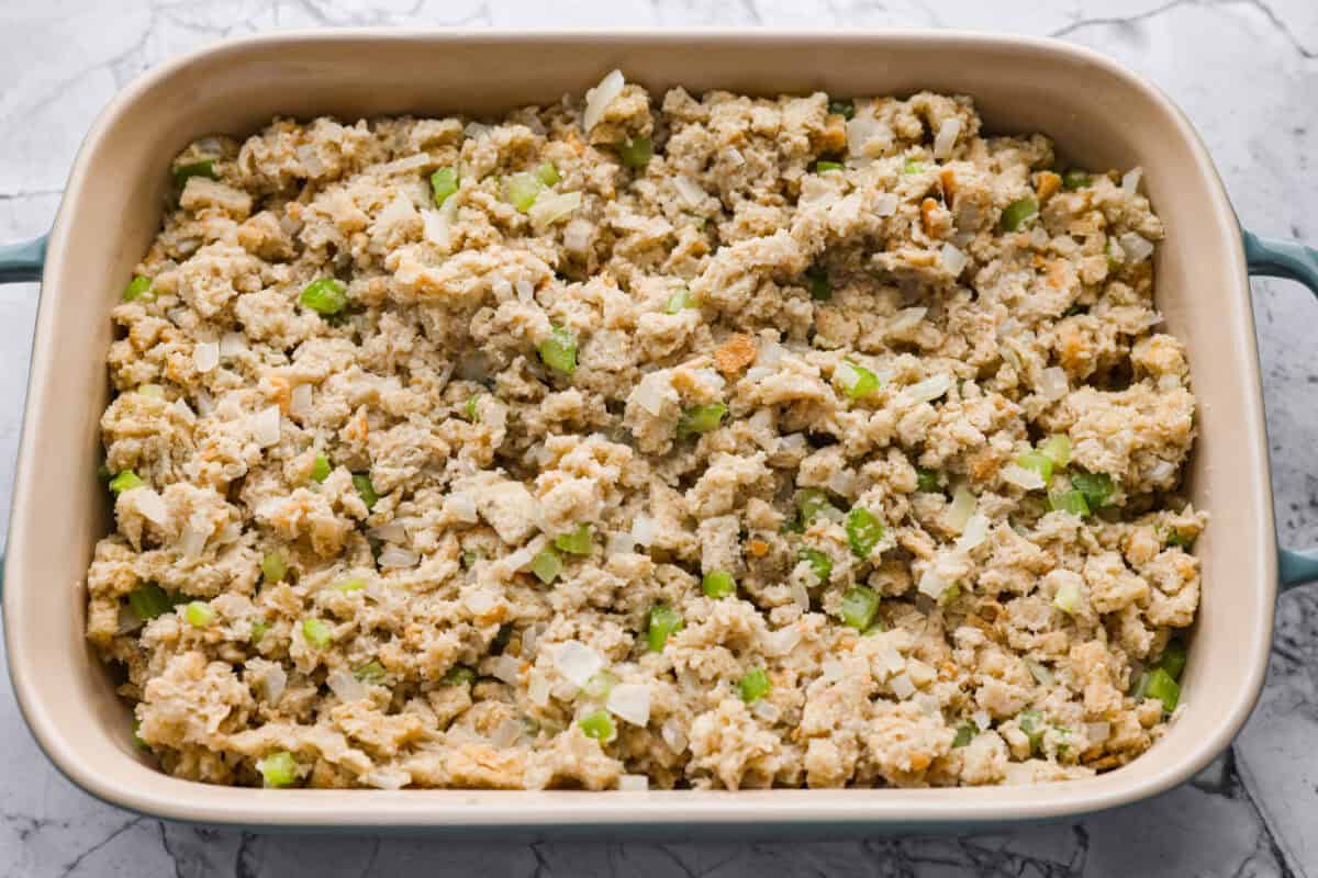 Stuffing ingredients added to the baking dish ready to go in the oven.