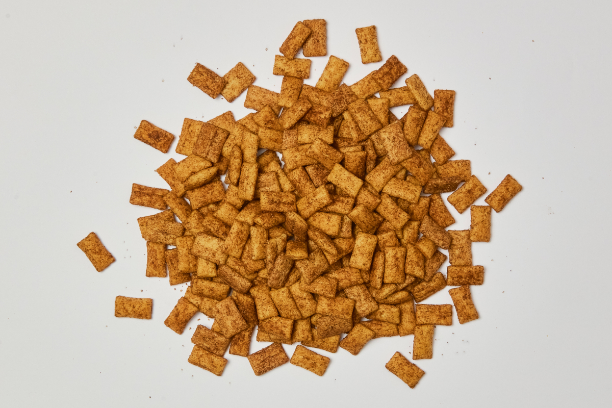 Pile of cinnamon crunch cereal. Sweetened wheat cereal with cinnamon and sugar. Breakfast food.