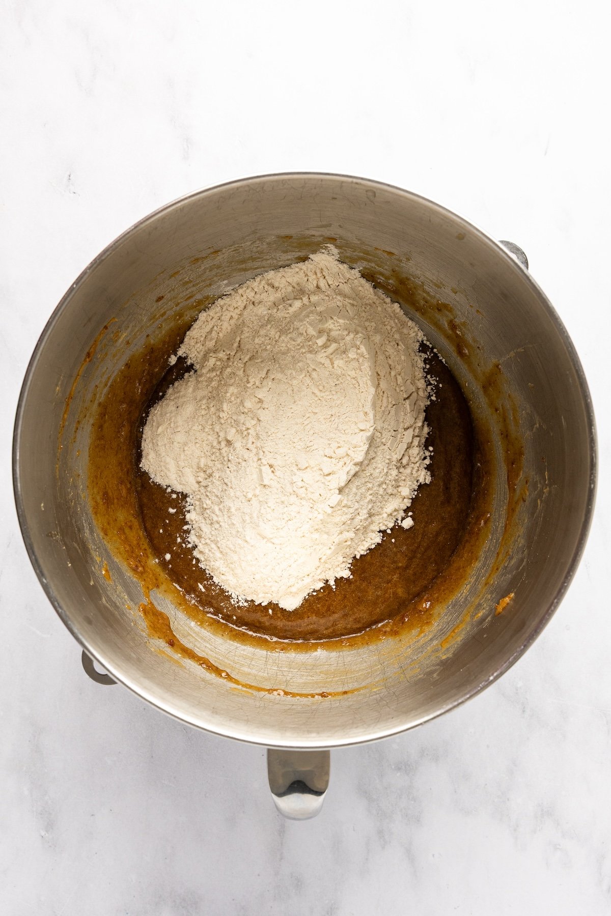 adding dry ingredients to mixing bowl