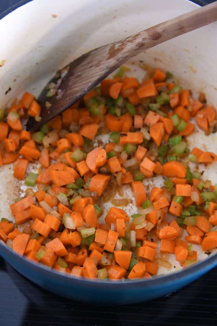 Soup pot with sauteed carrots, onions and celery.