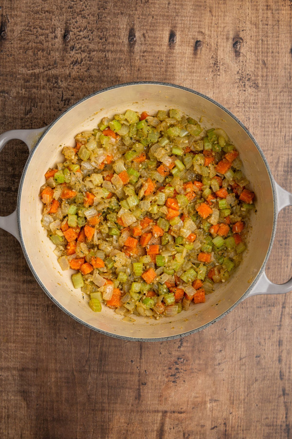 Dutch oven with flour combined with cooked vegetable mixture.