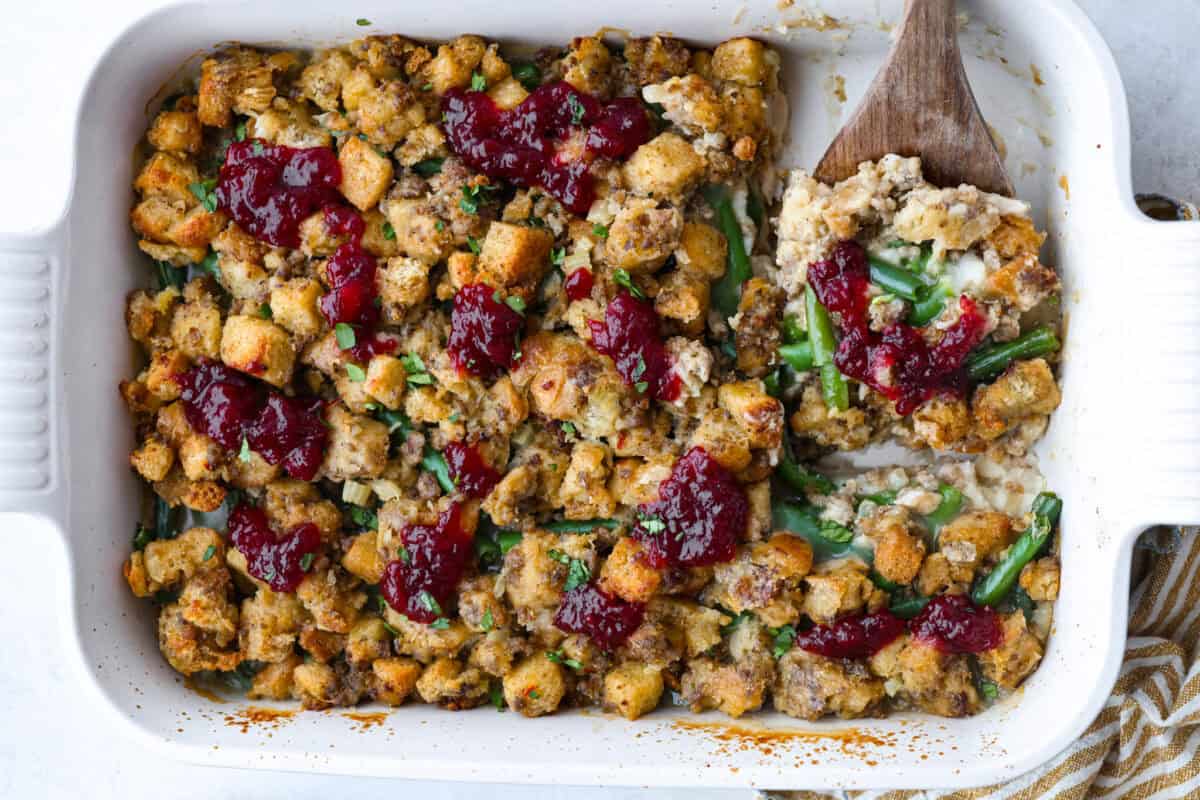 Thanksgiving leftover casserole all baked and topped with dollops of cranberry sauce. 
