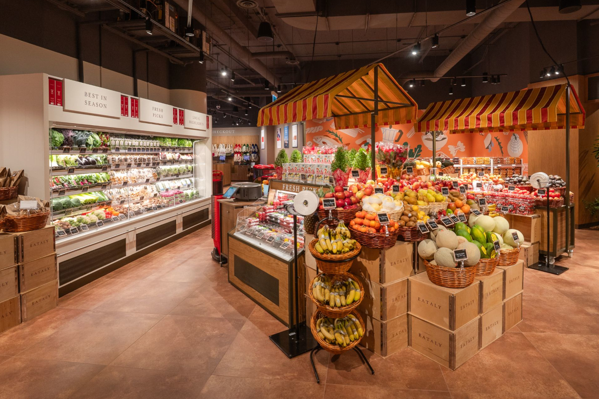 Eataly Eaton Centre Toronto produce section. Fresh fruits, vegetables, and market stall canopies.