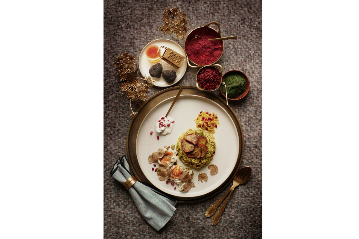 Gourmet truffle dish. Plate with rice, meat, and truffles. Bowls of red, green, and orange sauces. Urbani Tartufi.