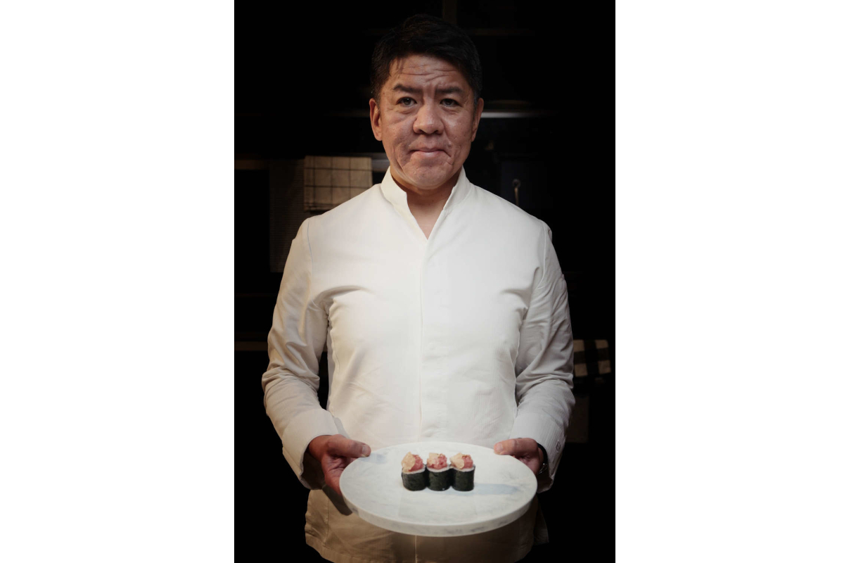 Chef Nobuya presents truffle sushi. Urbani Tartufi culinary artistry. Fine dining experience. Gourmet food.