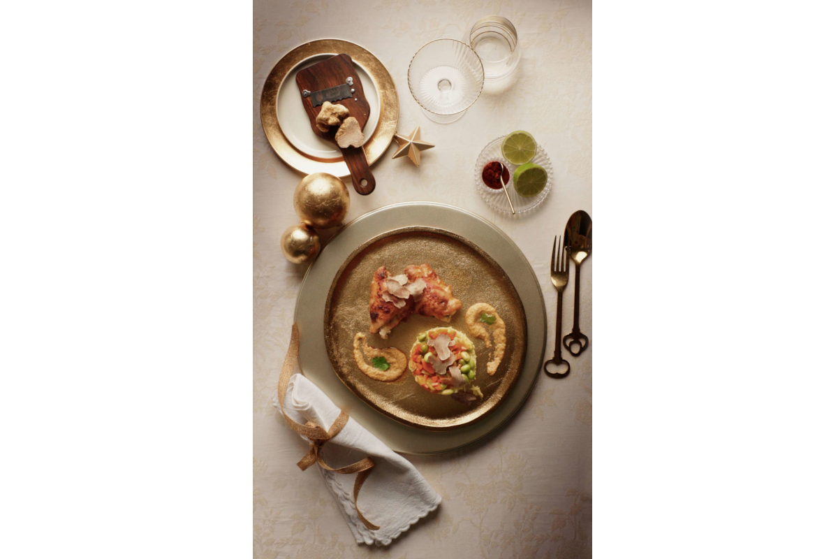 Gourmet truffle dish by Urbani Tartufi Chef Omar. Fine dining with gold accents, truffle shaver, and elegant presentation.