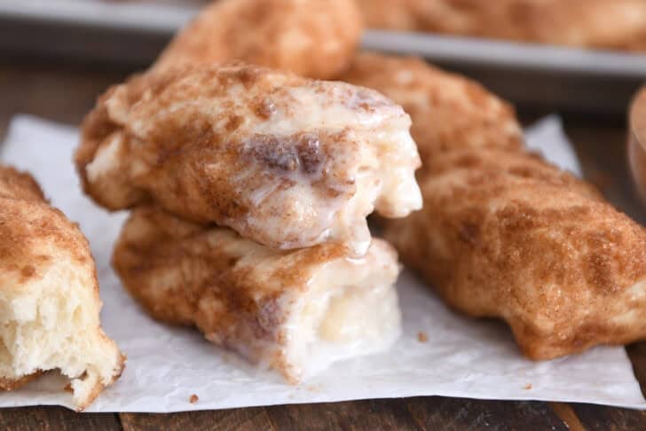 Two half cinnamon twists dipped in icing and stacked on each other.