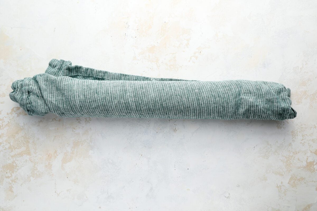 warm cake and towel rolled into a tight spiral