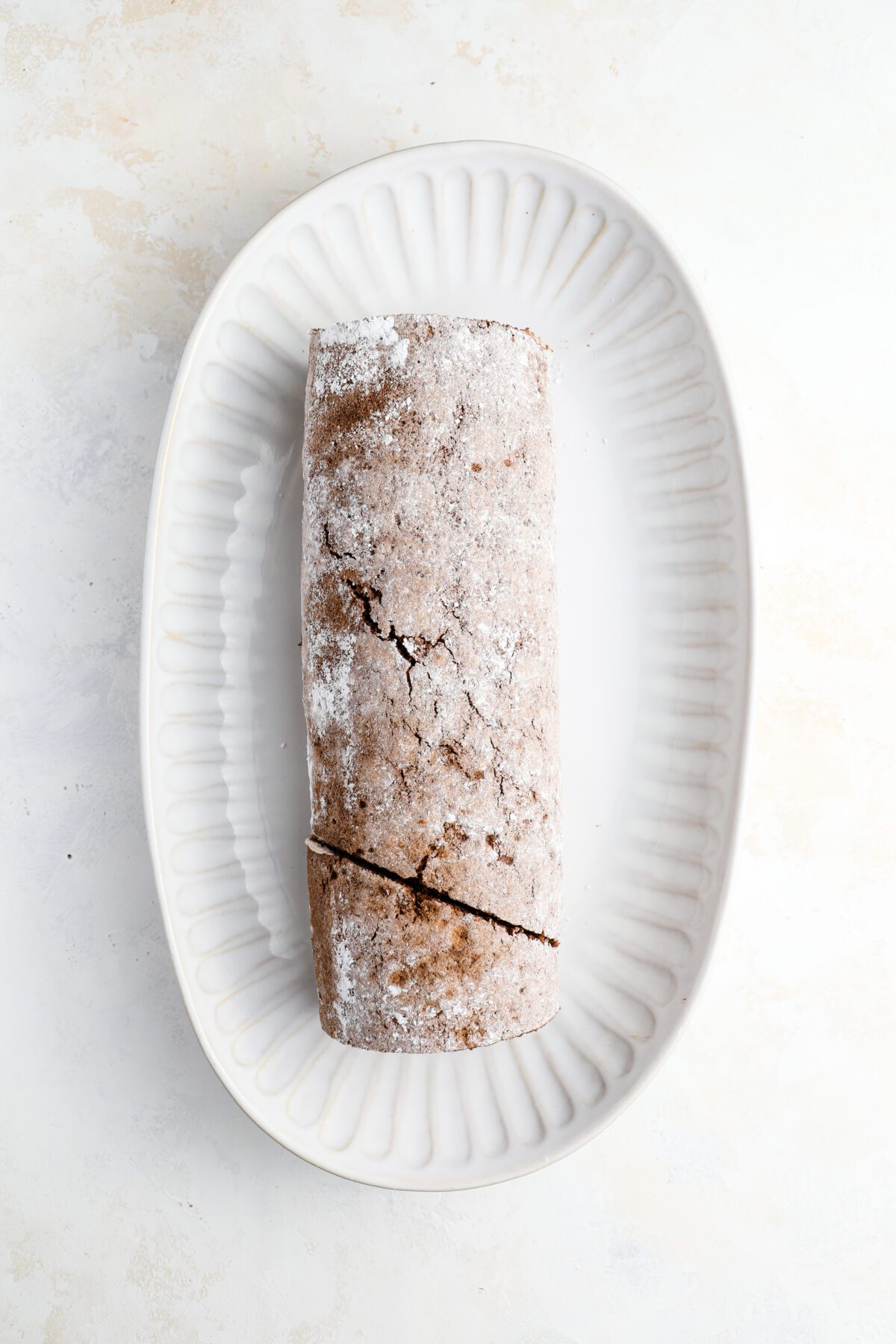 serving platter with diagonally sliced portion of cake