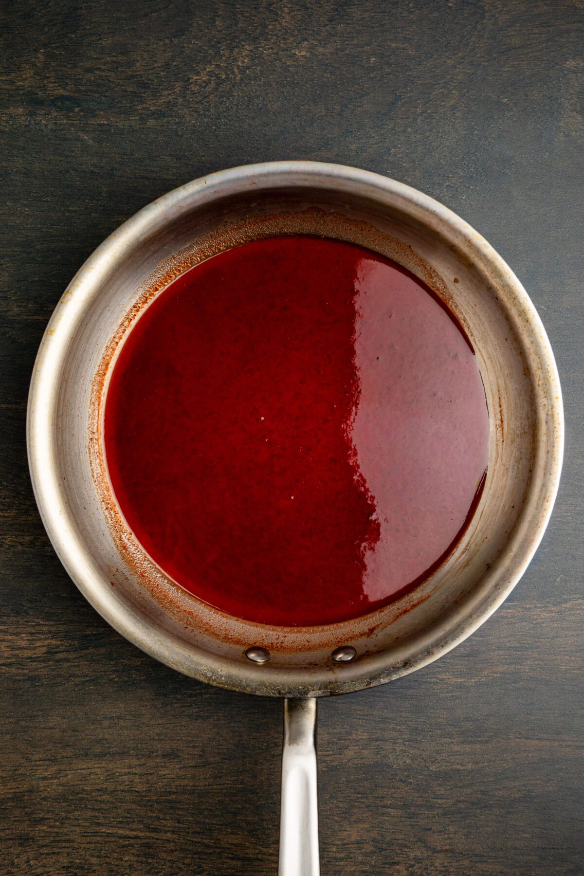 syrupy juice and ketchup mixture in nonstick skillet