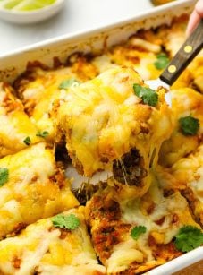 serving slice of stacked beef enchiladas.
