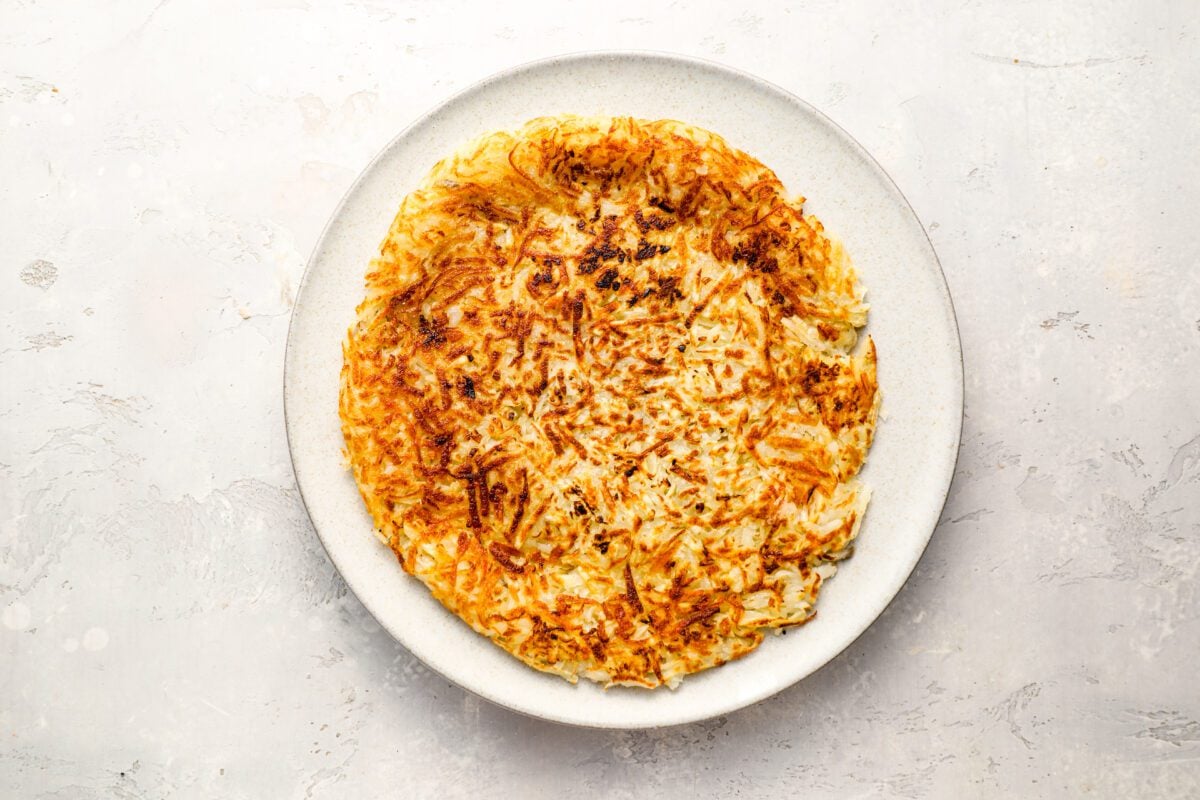 cooked-side up hash browns on a large plate