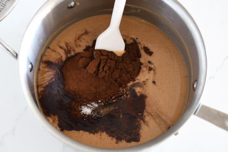 Saucepan with peanut butter, cocoa powder, and salt.