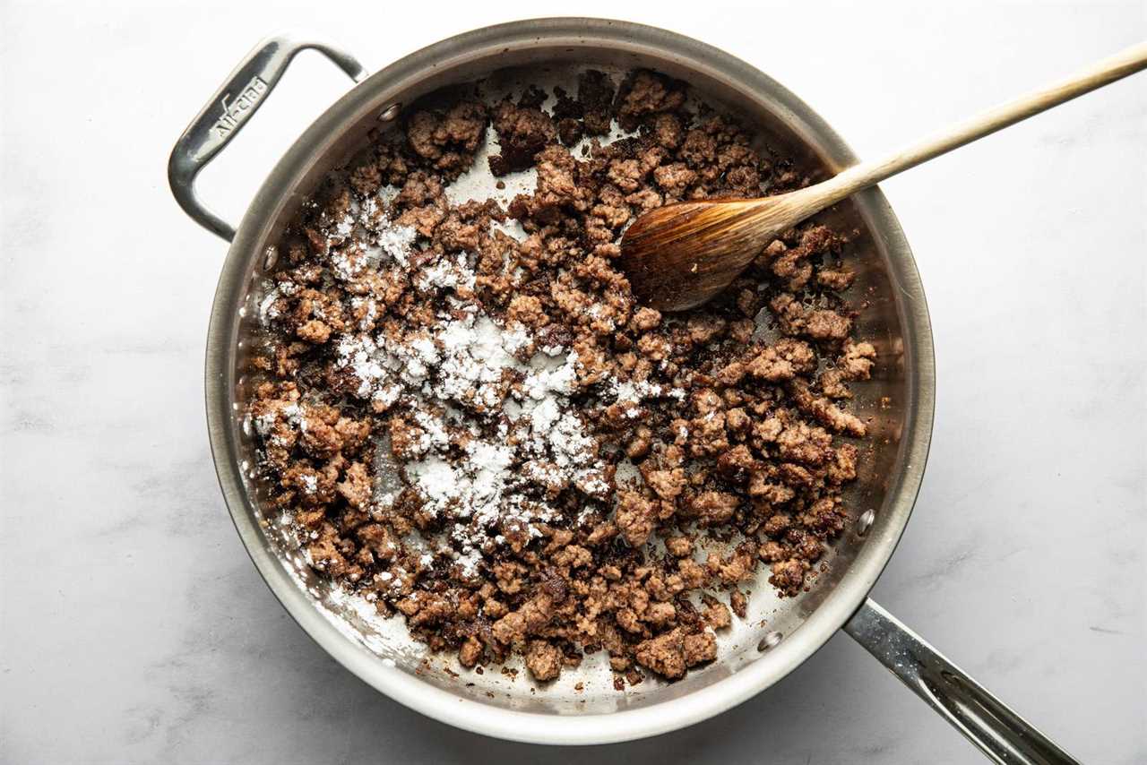 Browning beef in a skillet with cornstarch.
