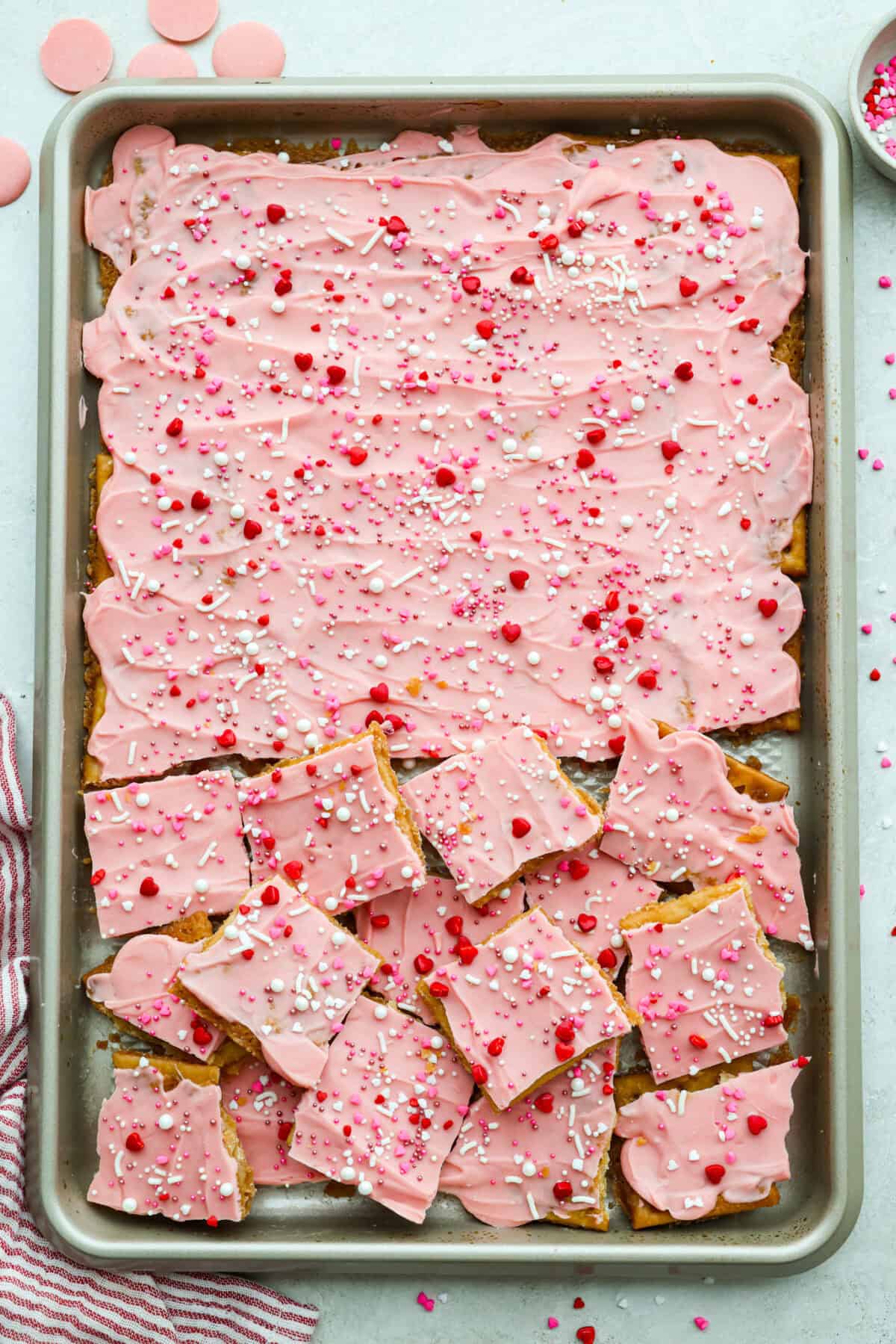 Valentine's themed sprinkles added to the spread out melted candy melts and cooled so the crack can be cracked into pieces. 