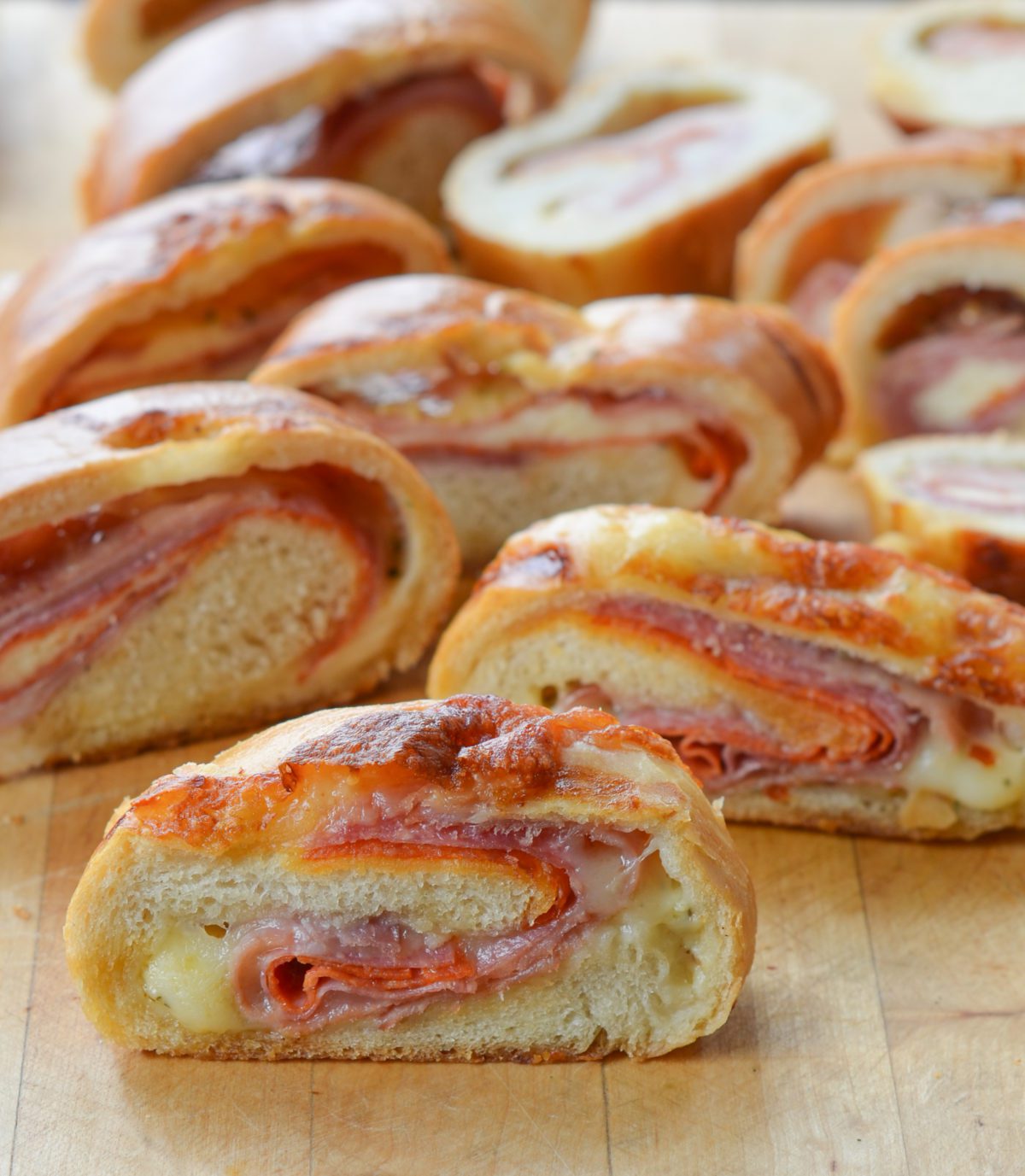 sliced stromboli on wood cutting board