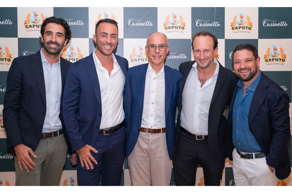 Group of men at Casinetto Eatbetter event. Business professionals in suits smiling.