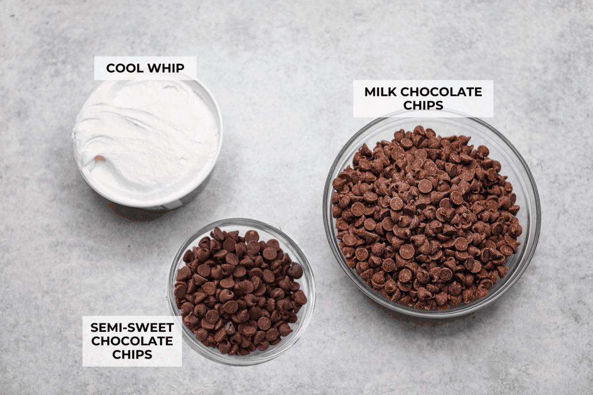 This 3 Ingredient Cool Whip Candy tastes just like a Three Musketeers! Fluffy on the inside, smooth chocolate on the outside, and so easy to make. It is the kind of treat you stash in the freezer and keep sneaking for yourself! Overhead shot of labeled cool whip candy ingredients.