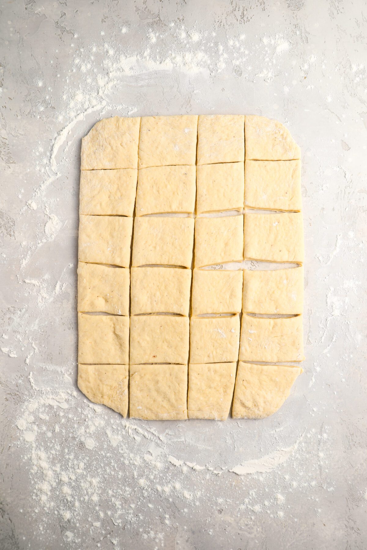 rolled and cut beignet dough on counter
