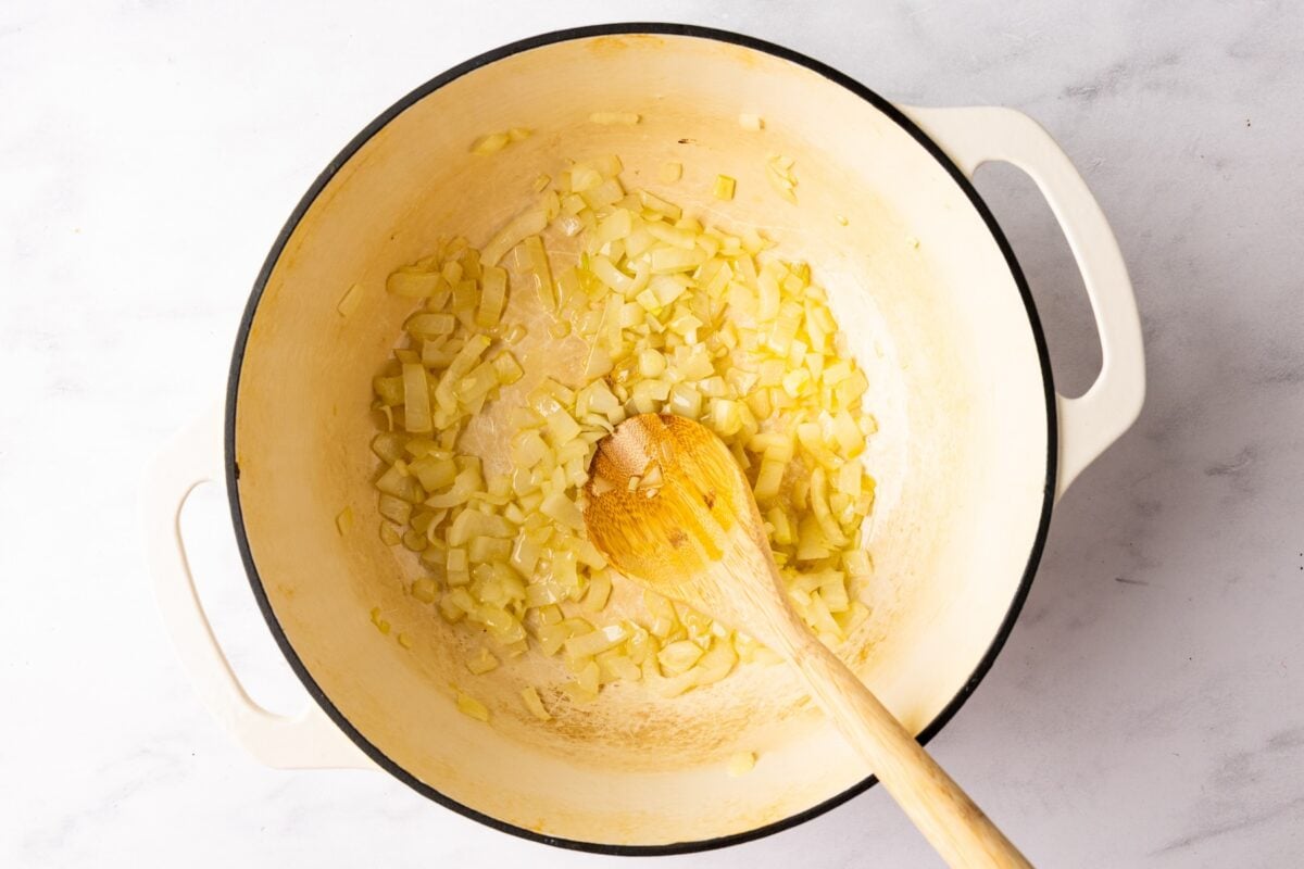 large Dutch oven with sautéed onion and garlic