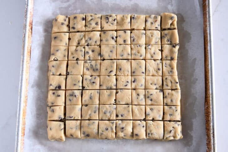 Cookie dough pressed into square and cut into 64 mini squares.