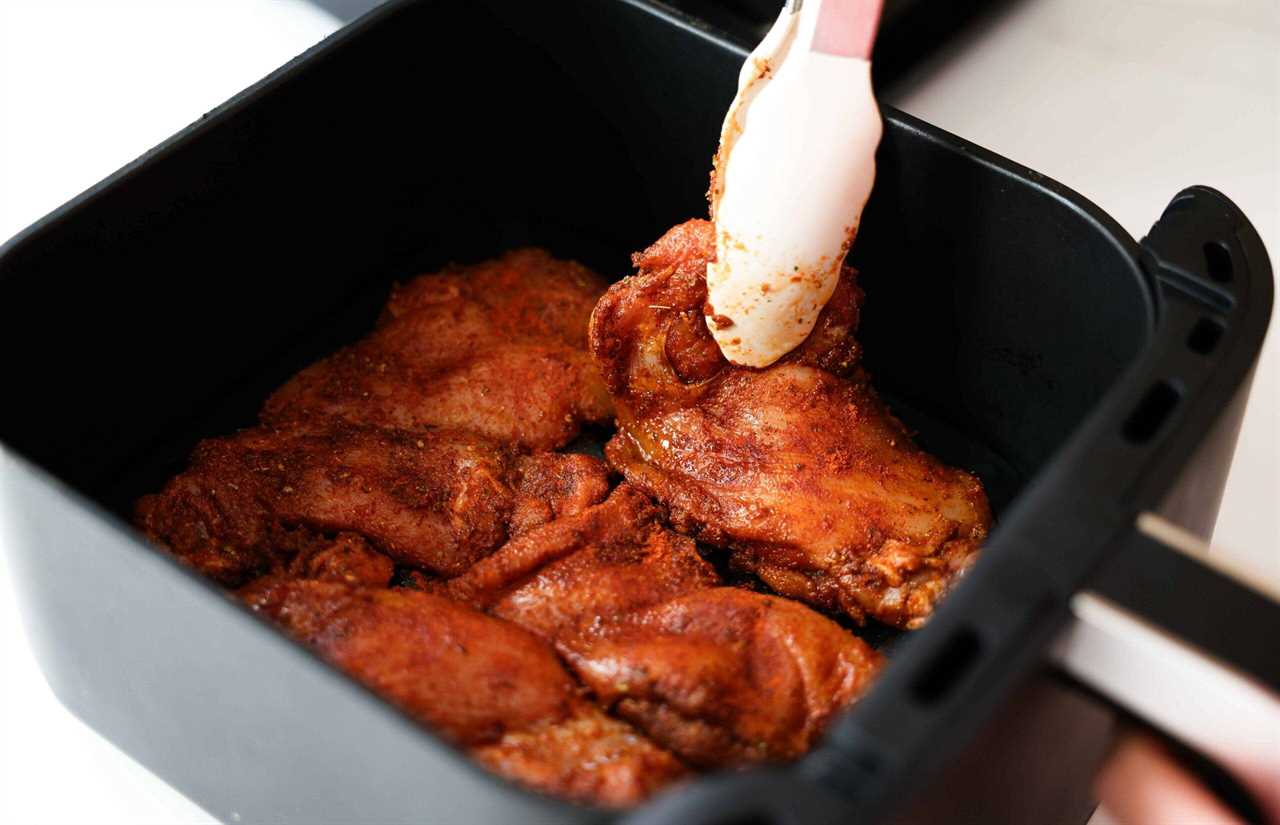 Putting the chicken thighs in the air fryer