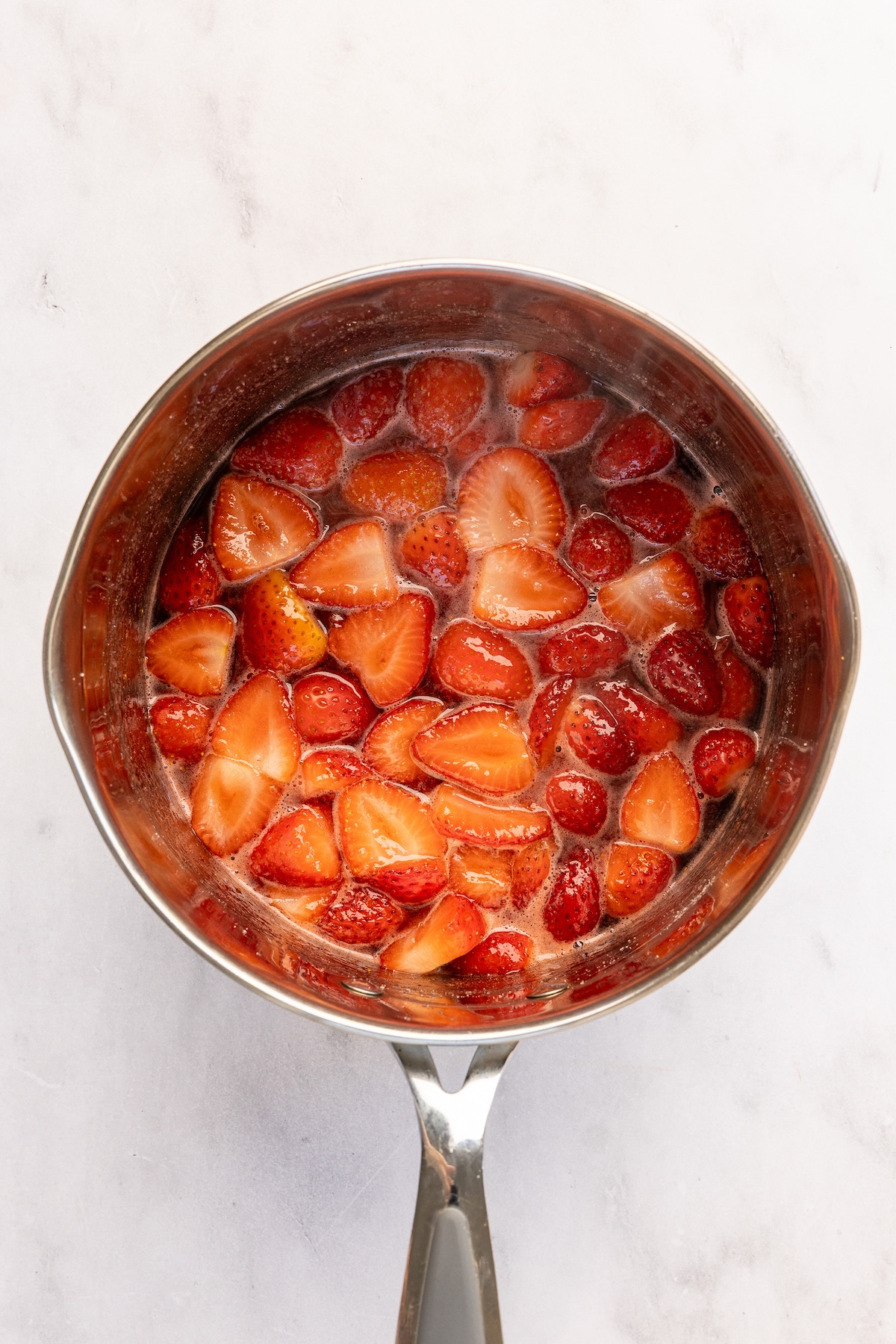 medium pot with strawberries, lemon juice and melted sugar