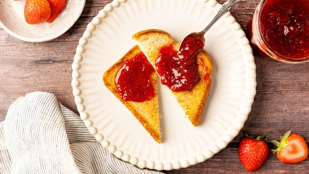 strawberry jam on toast on white plate