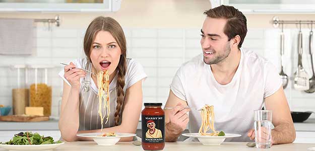 Heart healthy lycopene marinara sauce — couple cooking gourmet pasta dinner together at home