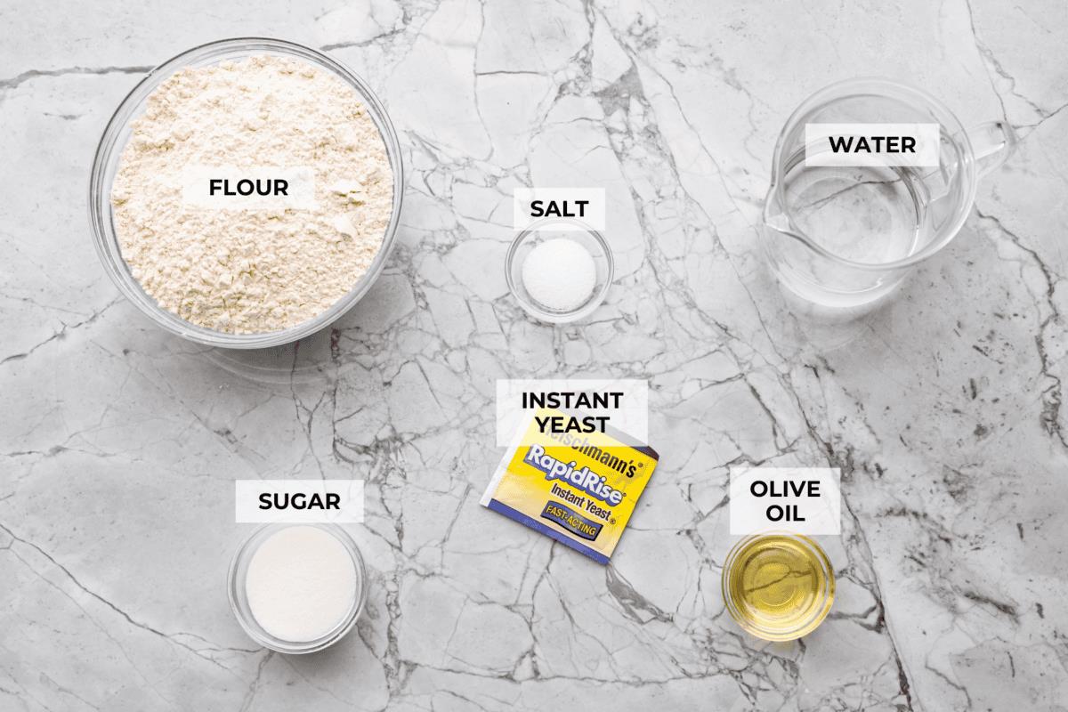 Overhead shot of labeled slow cooker bread ingredients. 