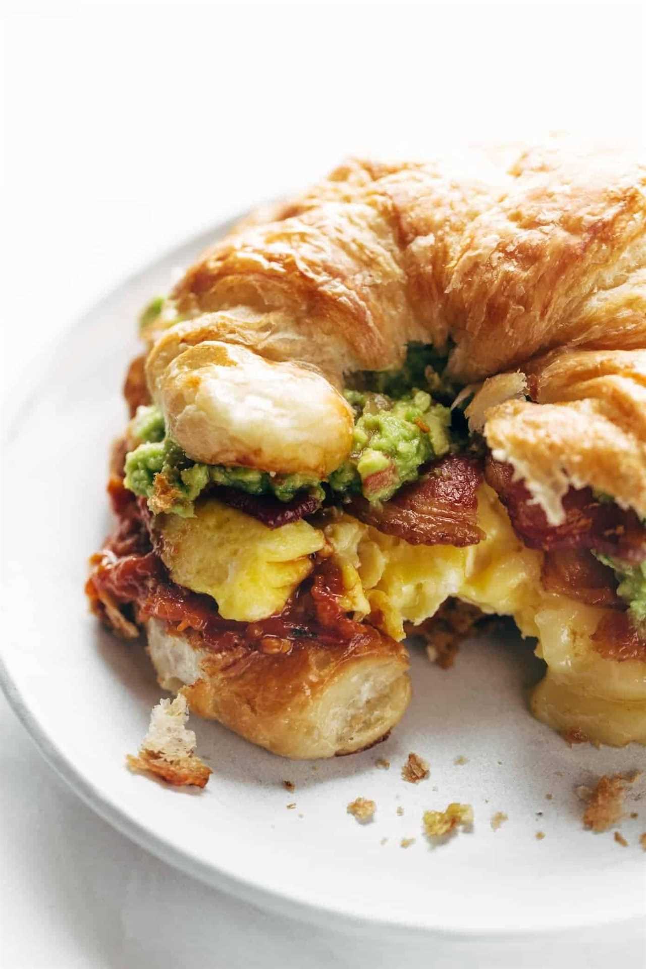 Croissant breakfast sandwich on a plate.