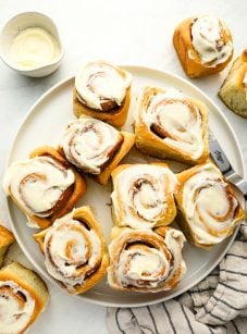cinnamon rolls with cream cheese frosting on platter