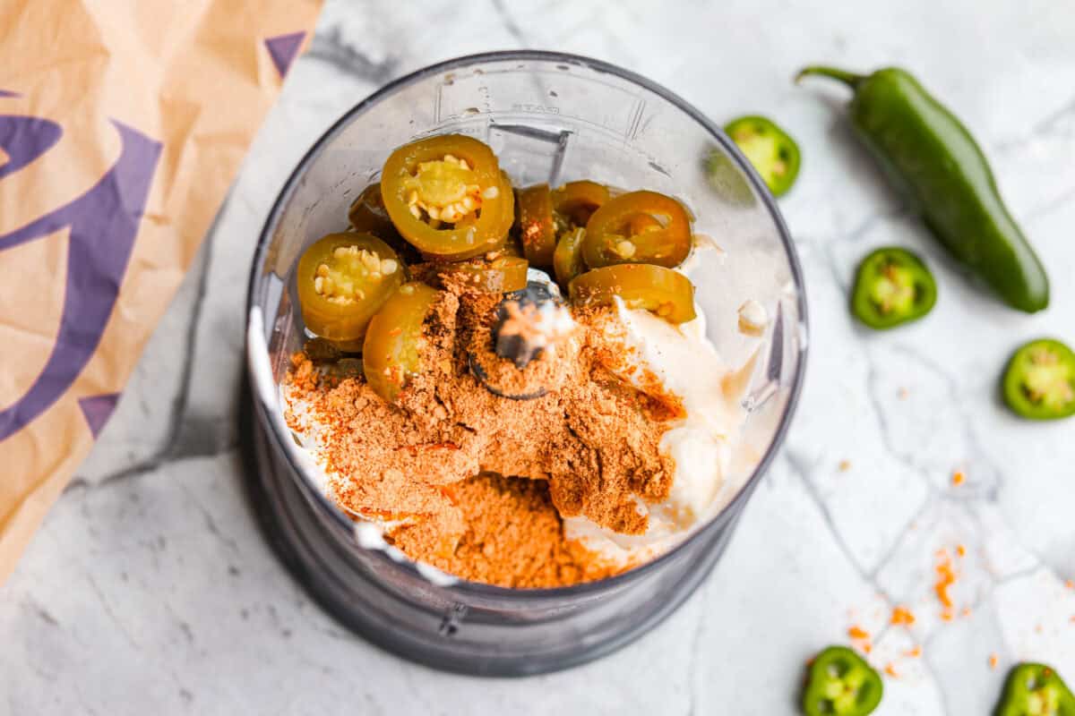 Food processor filled with all of the ingredients ready to be blended together. 
