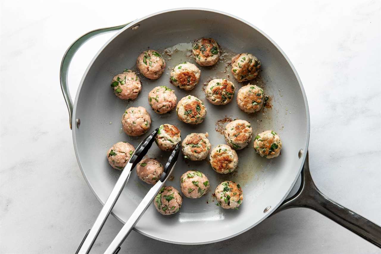 Cooking meatballs in a skillet.